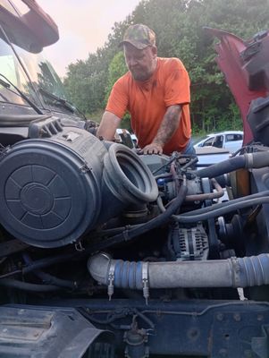 ATL Mobile Mechanics — Joseph hands-on with a diesel engine assembly, close-up of air intake and turbo work