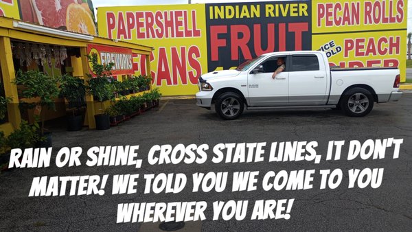 ATL Mobile Mechanics — branded service truck parked at a roadside Indian River Fruit stand with "Rain or shine, cross state lines, we come to you wherever you are" messaging
